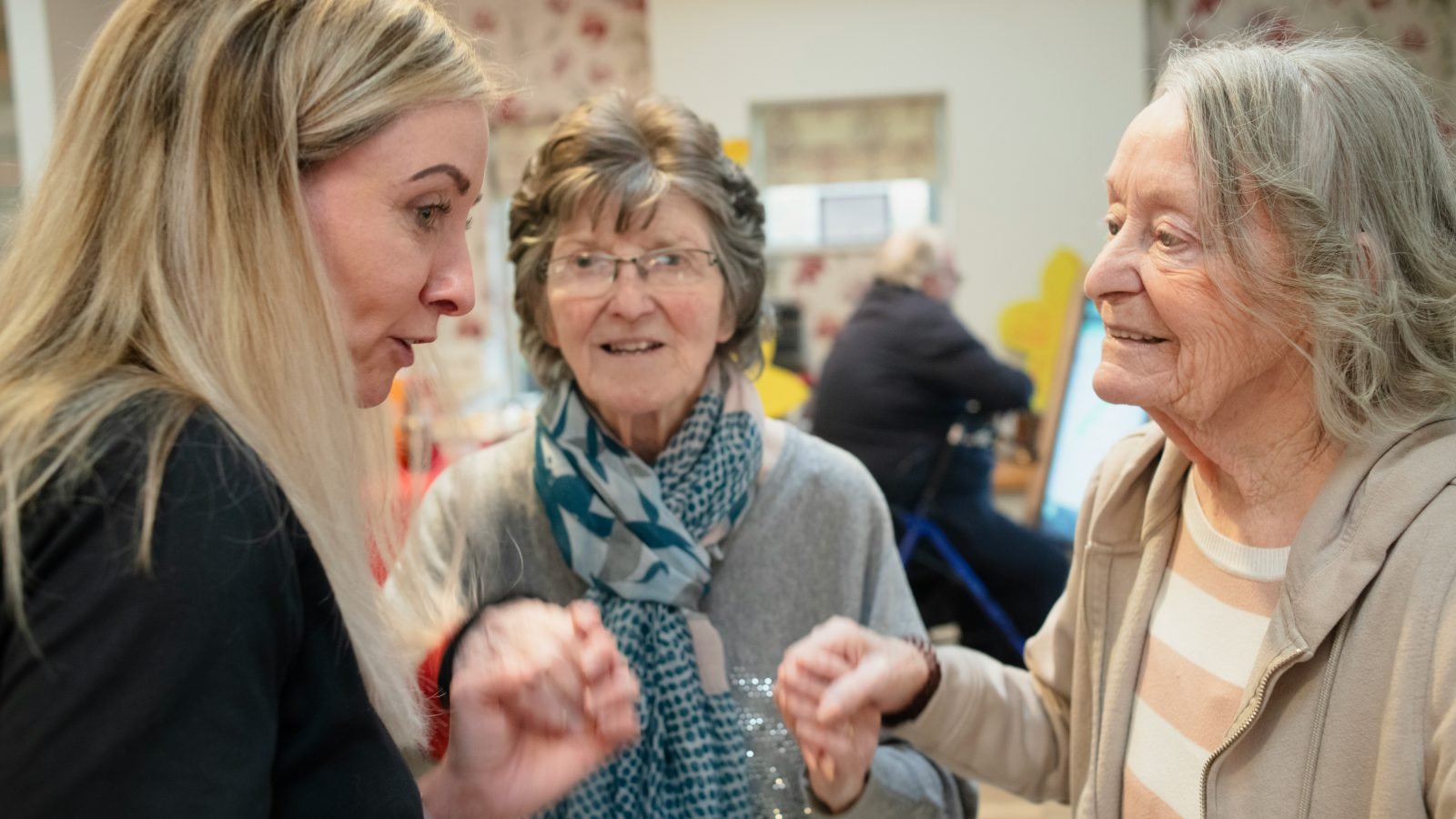 Caregiver and clients enjoying a community activity together